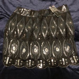 Black sequined mini skirt.